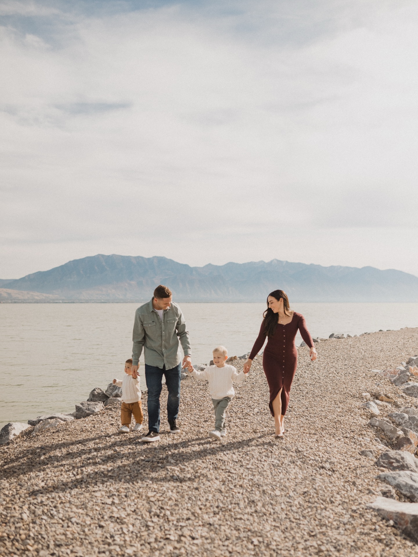 Elliott and Jackie with their two boys walking along the shore